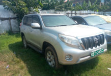 Another County vehicle hidden in a garage, missing some parts